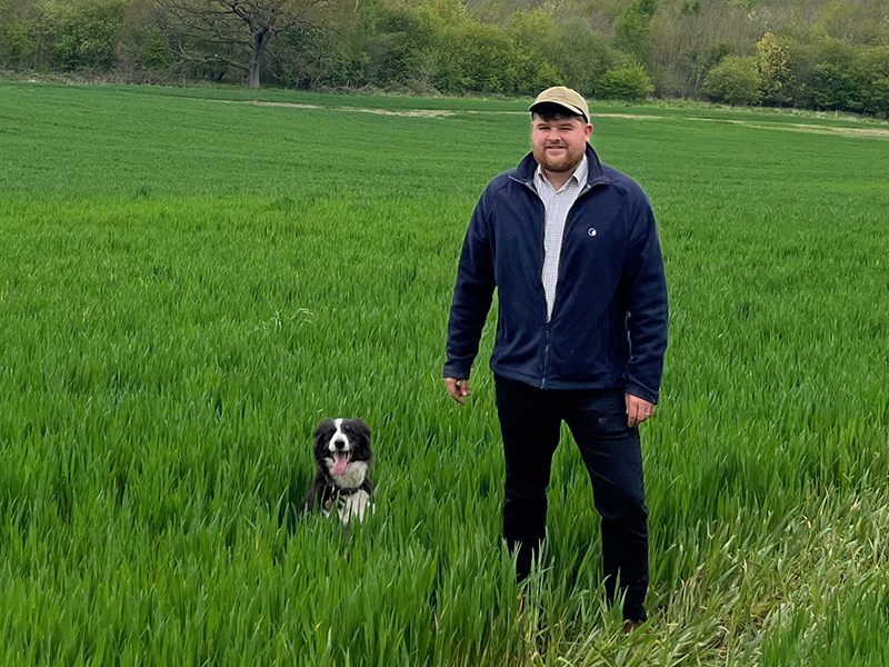 image of Lewis Bretton and dog in a field 